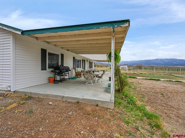 view of patio / terrace featuring a grill and a mountain view