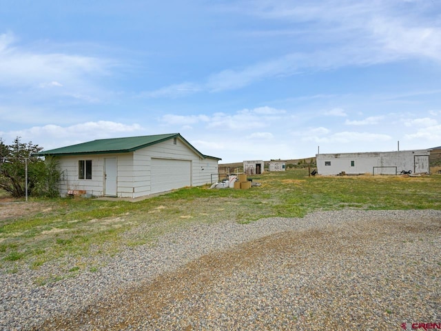 exterior space featuring an outbuilding and a detached garage