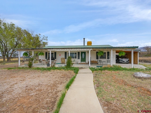 view of front facade with covered porch and metal roof