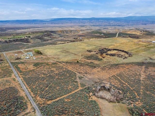 drone / aerial view featuring a mountain view and a rural view