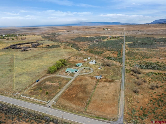 drone / aerial view featuring a rural view and a mountain view