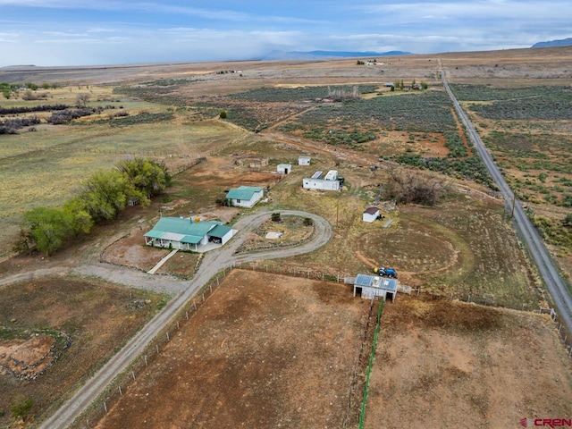 birds eye view of property with a mountain view and a rural view