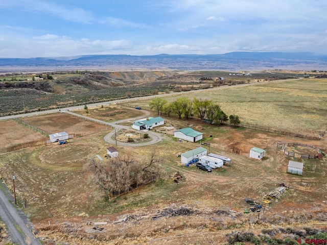 drone / aerial view featuring a rural view and a mountain view