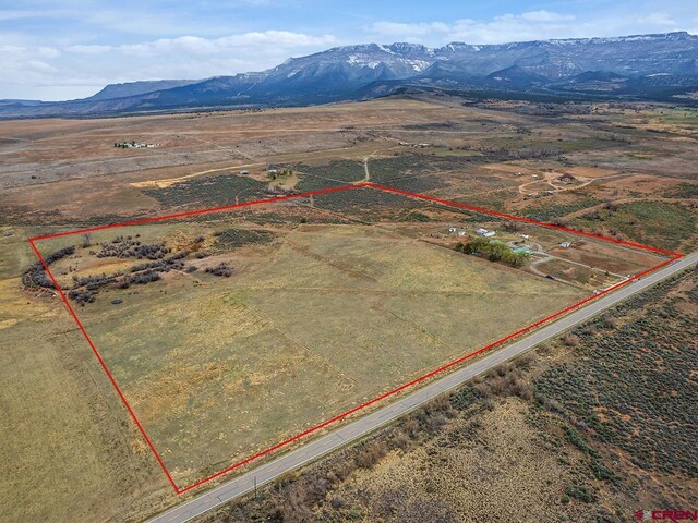drone / aerial view featuring a rural view and a mountain view