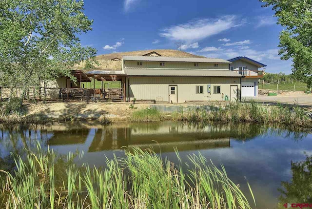 3575 E Rd, Palisade, CO 81526 - rear view of property with a garage and a water view