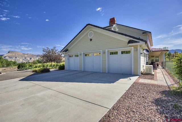 3575 E Rd, Palisade, CO 81526 - garage featuring a mountain view, fence, and driveway