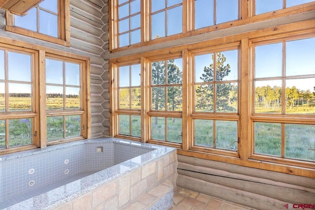unfurnished sunroom with a healthy amount of sunlight