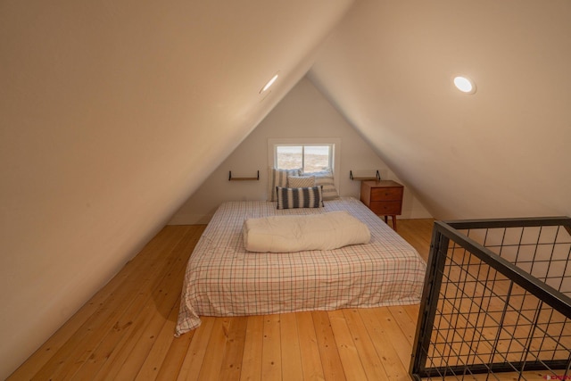 bedroom with wood-type flooring and lofted ceiling