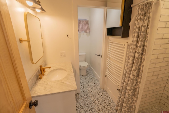 bathroom featuring toilet, vanity, tile patterned floors, and curtained shower