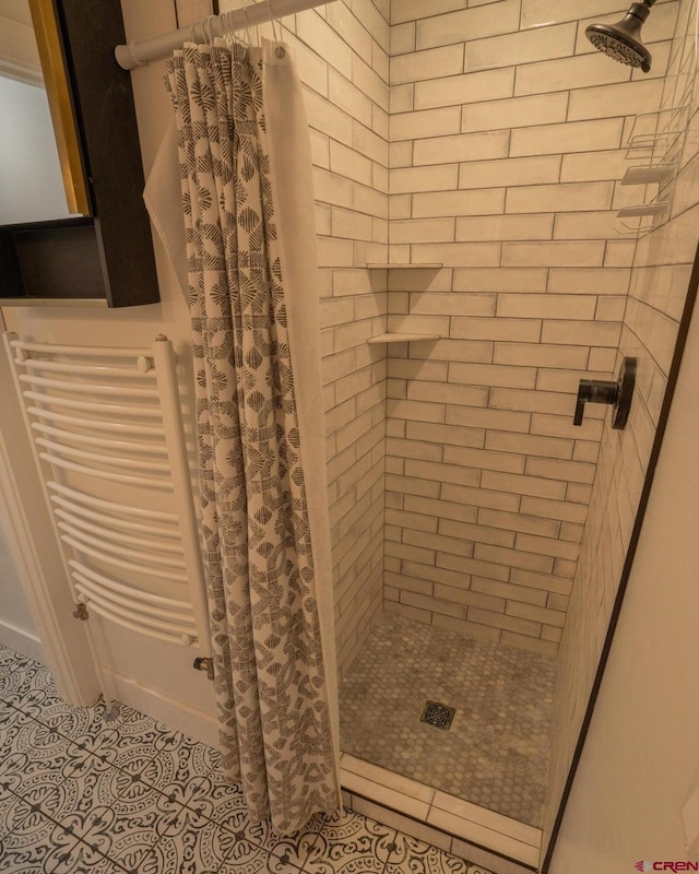 bathroom featuring tile patterned floors and a stall shower