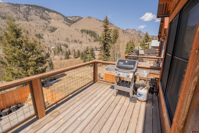 deck with grilling area and a mountain view