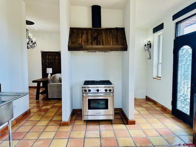 21 Hampton Run, Mosca, CO 81146 - kitchen with ventilation hood, stainless steel range, baseboards, and light tile patterned floors