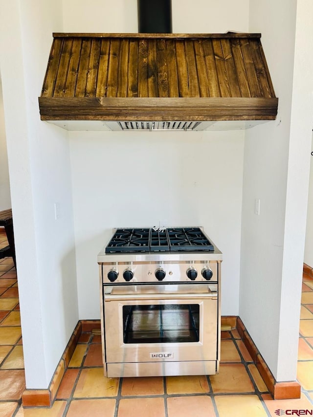 21 Hampton Run, Mosca, CO 81146 - kitchen featuring baseboards, high end stainless steel range oven, light tile patterned flooring, and custom range hood