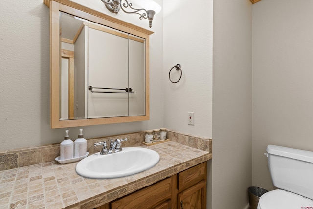 bathroom featuring toilet and vanity