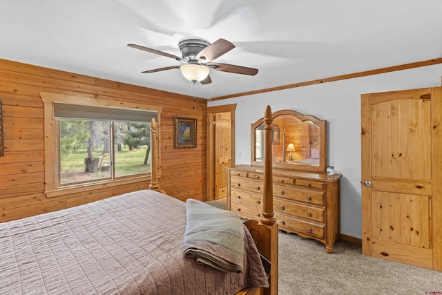 bedroom featuring light colored carpet, ceiling fan, and wood walls