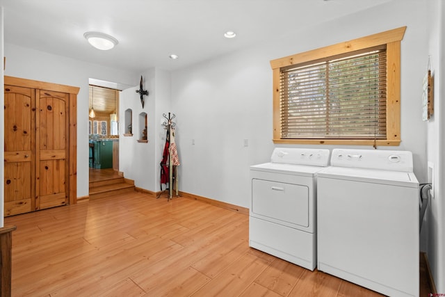 clothes washing area featuring recessed lighting, laundry area, light wood-style floors, baseboards, and separate washer and dryer