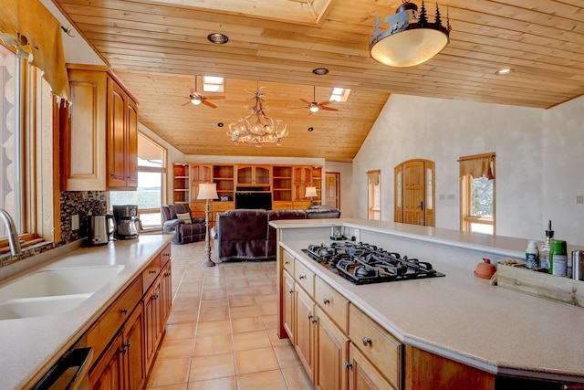 kitchen featuring a sink, vaulted ceiling, ceiling fan with notable chandelier, black gas stovetop, and wood ceiling