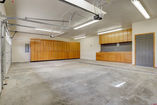 garage with a garage door opener and electric panel