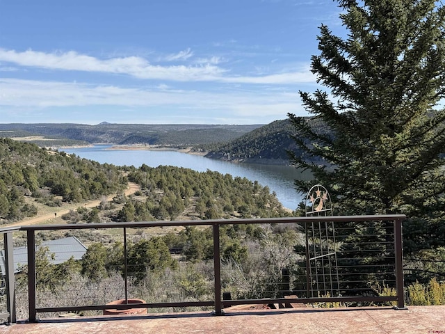 property view of water featuring a mountain view and a wooded view