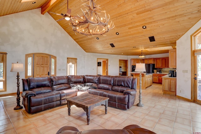 living room with wood ceiling, plenty of natural light, a notable chandelier, and light tile patterned floors