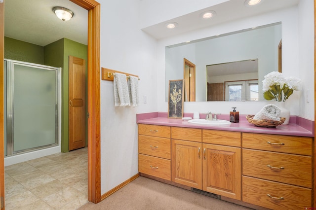 bathroom featuring visible vents, vanity, recessed lighting, and a shower stall