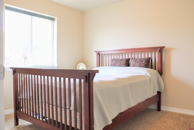 carpeted bedroom with baseboards