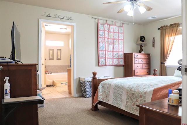 carpeted bedroom featuring visible vents and connected bathroom