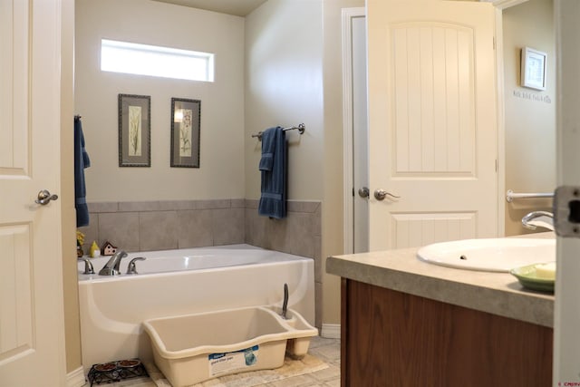 bathroom featuring a bath, vanity, and tile patterned flooring