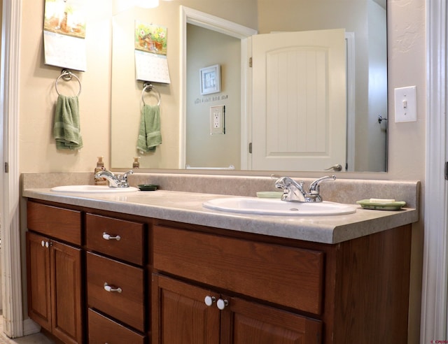 bathroom featuring a sink and double vanity