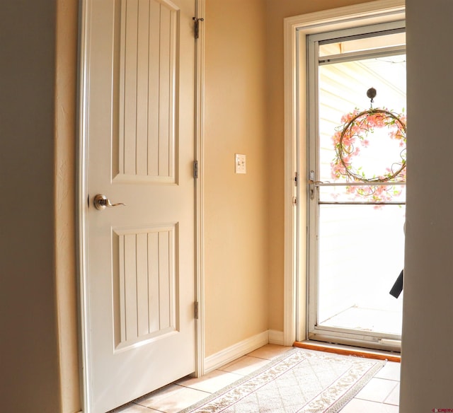 doorway to outside featuring a wealth of natural light and light tile patterned floors