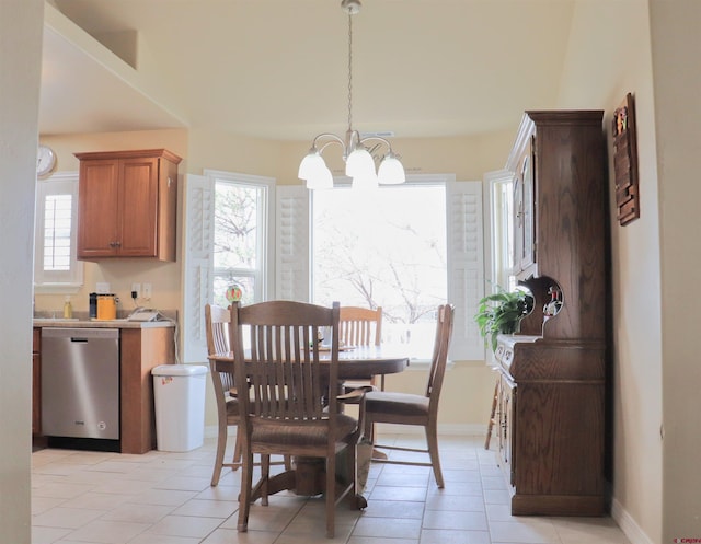 dining room featuring baseboards, a wealth of natural light, a notable chandelier, and light tile patterned floors