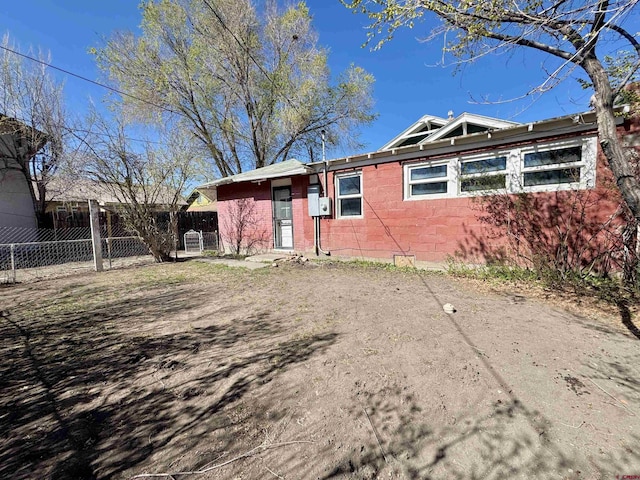 212 Bell Ave, Alamosa, CO 81101 - view of side of home featuring fence and concrete block siding