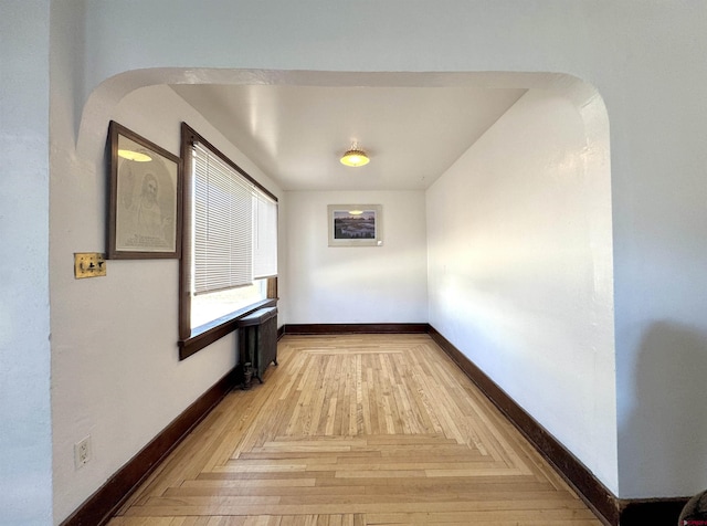 212 Bell Ave, Alamosa, CO 81101 - corridor with parquet flooring, baseboards, and arched walkways