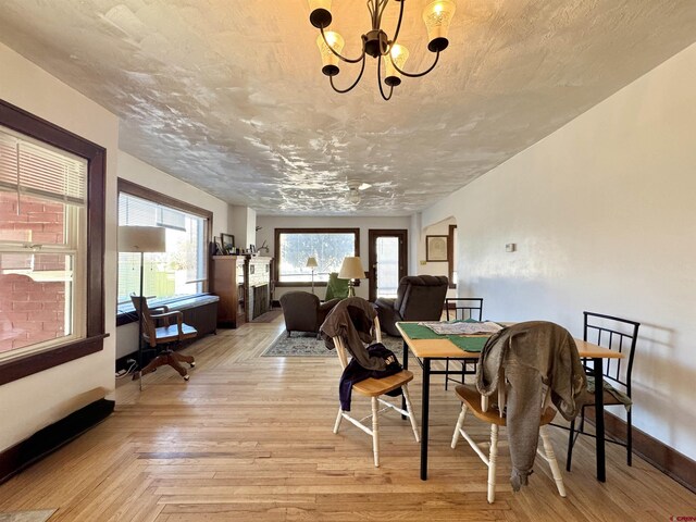 212 Bell Ave, Alamosa, CO 81101 - dining area featuring light wood-style flooring and a notable chandelier