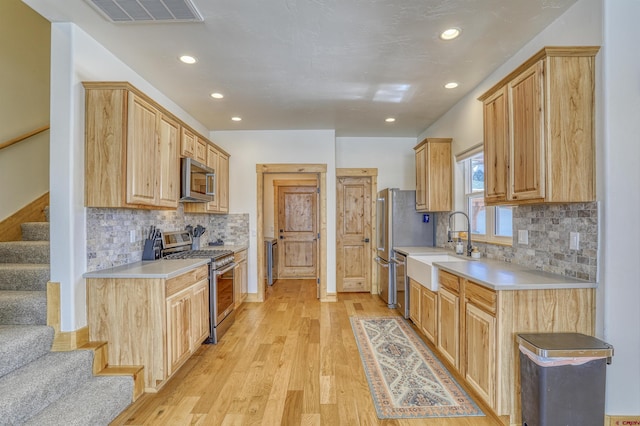 620 Lakeside Dr Unit C4, Pagosa Springs, CO 81147 - kitchen with light wood finished floors, recessed lighting, a sink, visible vents, and appliances with stainless steel finishes