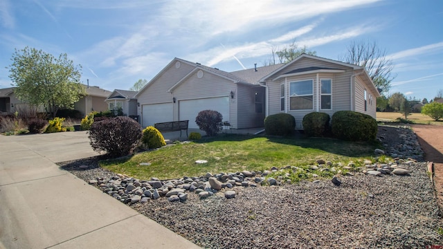single story home with a front lawn, driveway, and an attached garage