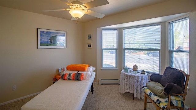 bedroom with multiple windows, light colored carpet, and a baseboard radiator