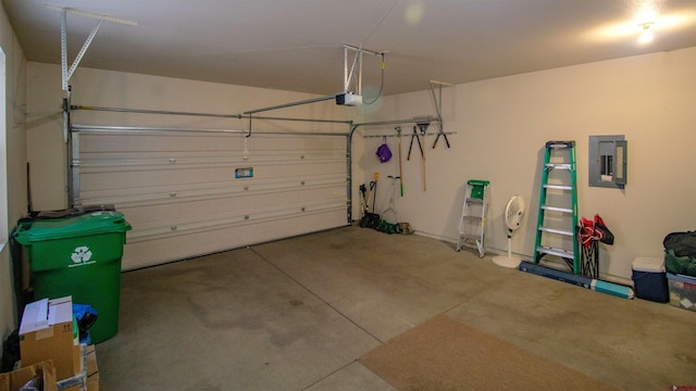 garage with a garage door opener and electric panel
