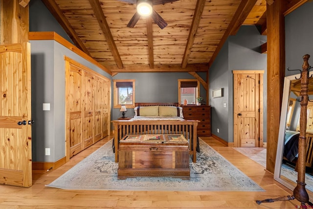 bedroom with light wood-style floors, baseboards, wooden ceiling, a ceiling fan, and vaulted ceiling with beams