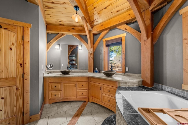 bathroom featuring tile patterned floors, vanity, and a bath