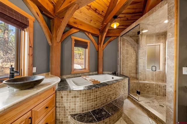 bathroom with wood ceiling, a shower stall, beam ceiling, a garden tub, and vanity