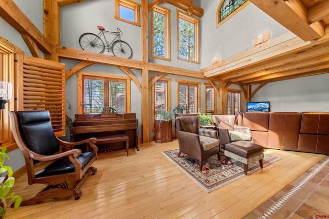 interior space featuring a towering ceiling, a wealth of natural light, and hardwood / wood-style flooring