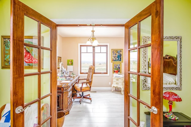 home office with baseboards and french doors