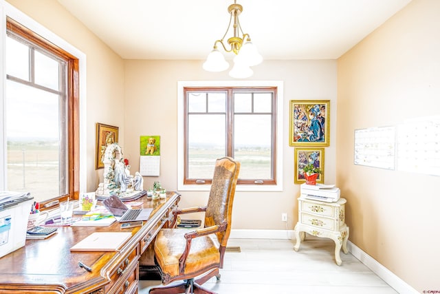 office with baseboards, a chandelier, and a wealth of natural light