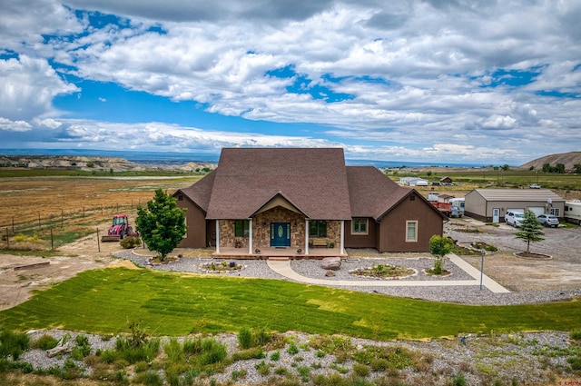 view of front of house with a front yard, a porch, and stone siding