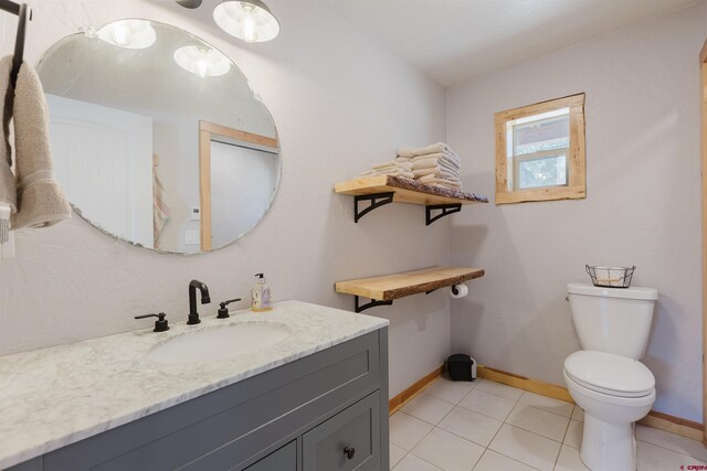 85 Mclain Ct, Pagosa Springs, CO 81147 - bathroom with baseboards, tile patterned floors, vanity, and toilet