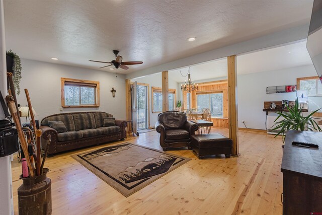 85 Mclain Ct, Pagosa Springs, CO 81147 - living area featuring light wood-style floors, plenty of natural light, ceiling fan with notable chandelier, and recessed lighting