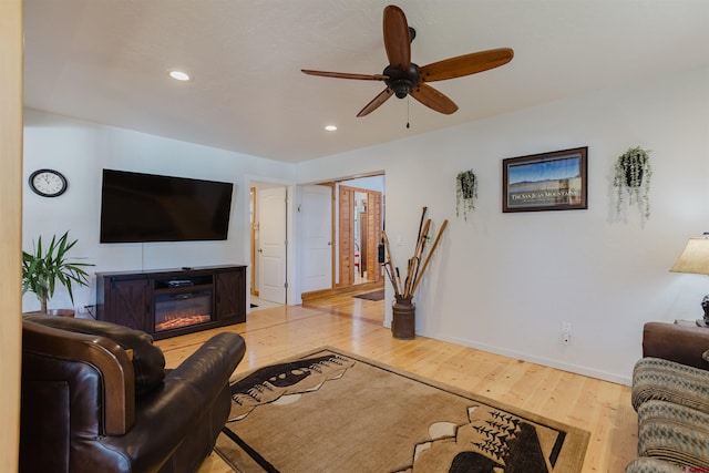 85 Mclain Ct, Pagosa Springs, CO 81147 - living room featuring ceiling fan, wood finished floors, baseboards, a glass covered fireplace, and recessed lighting