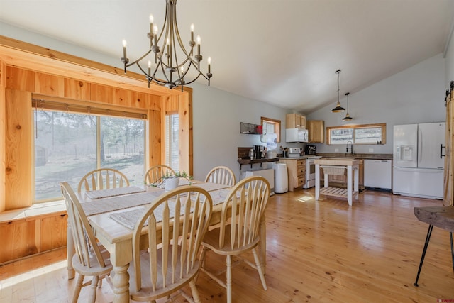 85 Mclain Ct, Pagosa Springs, CO 81147 - dining space with high vaulted ceiling, a chandelier, and light wood-style floors