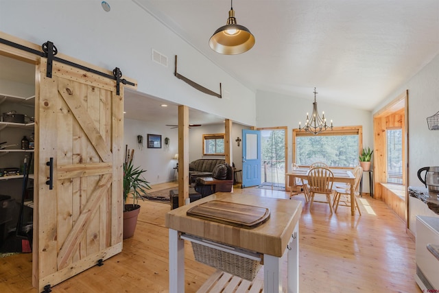 85 Mclain Ct, Pagosa Springs, CO 81147 - dining room with plenty of natural light, vaulted ceiling, a barn door, and visible vents